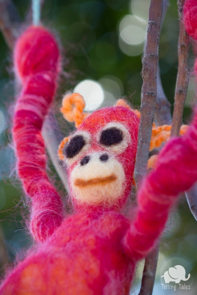 Chilli, the orangutan felted marionette looking out at the trees